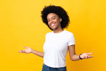 Young African American woman isolated on yellow background happy and smiling