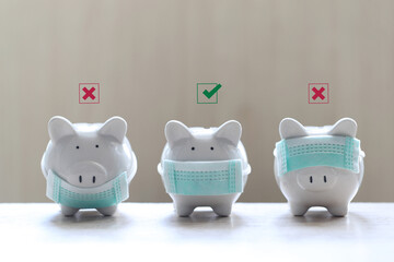 Piggy bank showing how to wearing protective medical mask correct for protect smog or PM 2.5 and viruses on wooder background, Medical insurance and Health care concept