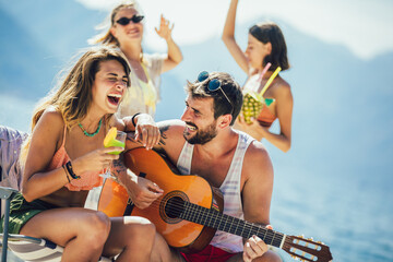 Young friends having fun at the beach on a sunny day.