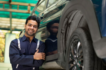 Portrait of happy mechanic in auto repair shop	