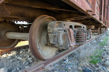 Industrial rail car wheels closeup photo. Old rusty train wheels. Wheel train system on track.