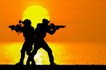 Fototapeta na wymiar A black silhouette of an american soldier patrolling the sunset