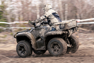 Fototapeta premium Quad competition. Dirty quad starting in a extreme competition. Dynamic shot of racer on quad motorbike in the race