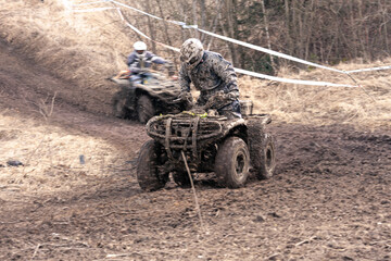 Quad competition.  Dirty quad starting in a extreme competition. Dynamic shot of racer on quad...