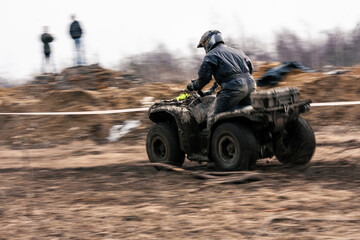 Quad competition.  Dirty quad starting in a extreme competition. Dynamic shot of racer on quad...