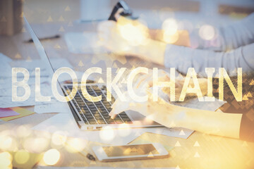 Double exposure of woman hands typing on computer and crypto market theme hologram drawing. Blockchain concept.