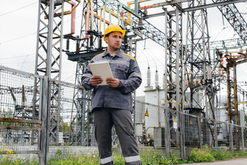 The energy engineer inspects the equipment of the substation. Power engineering. Industry