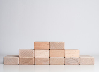 pyramid of wood blocks on the white background with copy space