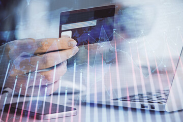 Multi exposure of woman on-line shopping holding a credit card and financial graph drawing. Stock market E-commerce concept.