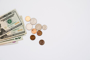Dollar bills and coins on the white background