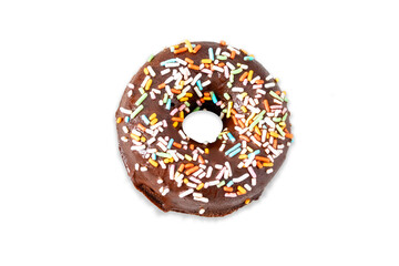Donut with colorful sprinkles on white background.