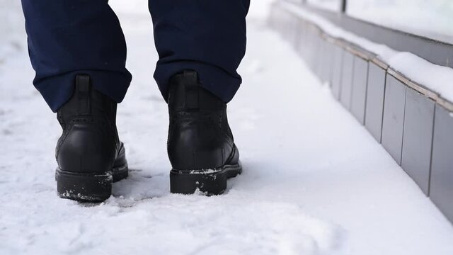 Close-up, shoes and snow on the street in winter, loss and loss of a wallet, distraction and not being attentive. Lose money and wallet with credit cards and documents.