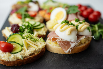 col cut meat egg mayonnaise salad proscuito ham cucumbr cheese open sandwich board selection 
