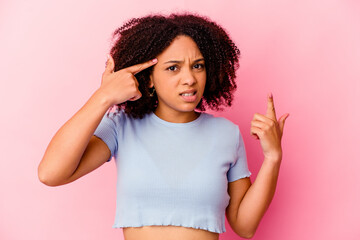 Young african american mixed race woman isolated showing a disappointment gesture with forefinger.