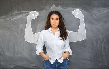 portrait of young self-confident woman looks in camera and shows muscle