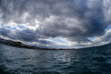 clouds over the mountains and sea oropos city greece