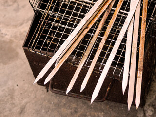 Dirty skewers on grill after barbecue