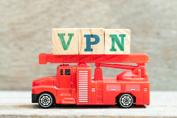 Fire ladder truck hold letter block in word VPN (abbreviation of virtual private network) on wood...