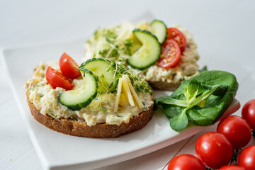 Fototapeta na wymiar egg cheese tomoto cucumber open sandwich dip bread spread party finger food lunch snack