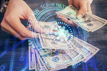 Double exposure of technology drawing hologram and us dollars bills and man hands. Data concept