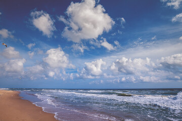Seascape on a sunny day. Stormy sea with a beautiful cloudy sky. Nature landscape