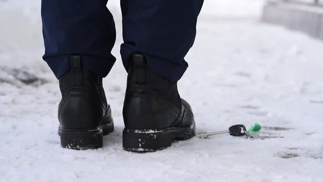 Close-up, shoes and snow on the street in winter, loss and loss of keys, absent-mindedness and inattention. Lose the keys to the house and apartment.