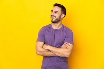 Young caucasian handsome man isolated on yellow background happy and smiling