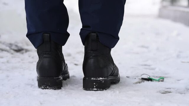Close-up, shoes and snow on the street in winter, loss and loss of keys, absent-mindedness and inattention. Lose the keys to the house and apartment.