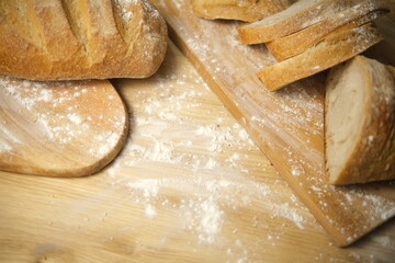 Bread sliced and freshly baked on a wooden table. Flour, bakery. The cooking process is captured in 4k resolution. Selective Focus