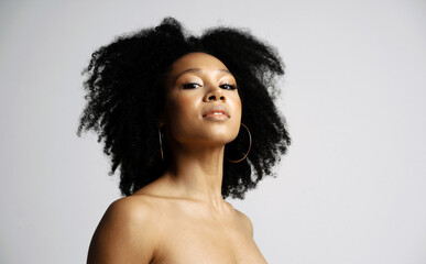 Black healthy curly hair. Clean, even skin of the face. portrait of a female model of Latin...