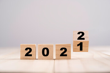 Merry Christmas and happy new year concept, Flipping of wooden cube block change from 2021 to 2022.