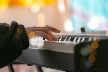 close up of a hand playing the piano