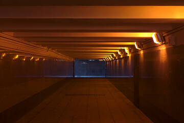 underground pedestrian crossing, illuminated by orange lamps