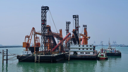 Two vessel of self-unloading bulk with belt conveyer carrier stiuated with tugboat on sea.