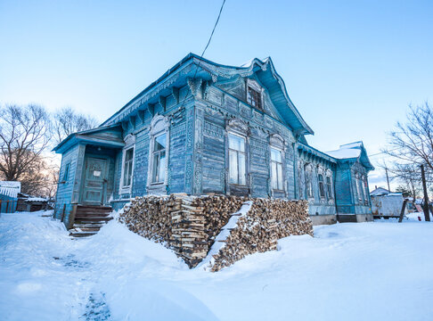 Blue house with wooden carvings in Porechye, Russia