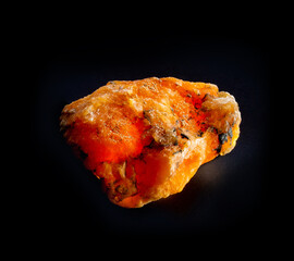 Red orange gypsum mineral crystal from Luban, Belarus. A backlight photo of a stone isolated on black. Geology websites, stone collection catalog, Natural Science museum wall chart.