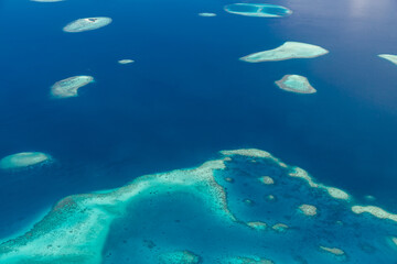 Fototapeta na wymiar Islands aerial view. Aerial photo of beautiful Maldives paradise tropical beach. Coral reef, blue turquoise lagoon water. Luxury travel