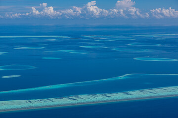 Fototapeta na wymiar Islands aerial view. Aerial photo of beautiful Maldives paradise tropical beach. Coral reef, blue turquoise lagoon water. Luxury travel
