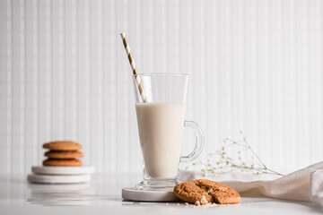Glass of milk with homemade cookies on a white background. Breakfast and healthy food concept. white on white