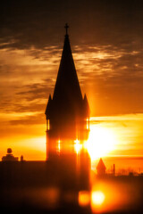 Fototapeta sunrise behind a church steeple obraz