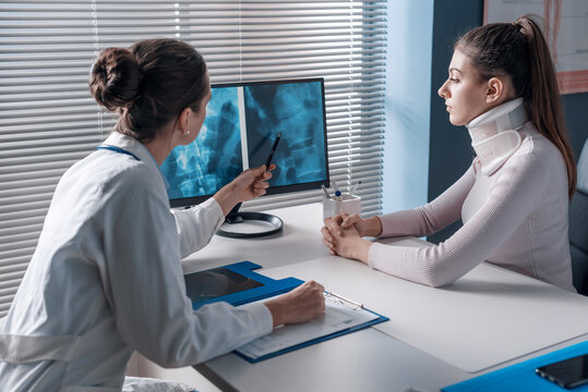 Injured woman with cervical collar in the doctor's office