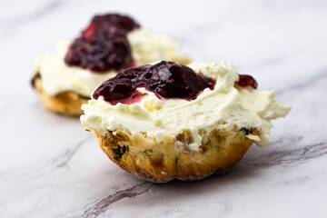 Fruit scone with strawberry jam and cream