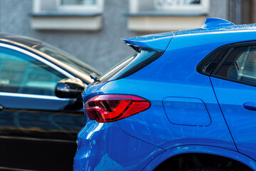 close-up of a blue car parked on the side of the street