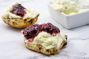Fruit scone with strawberry jam and cream