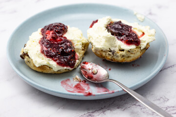 Fruit scone with strawberry jam and cream