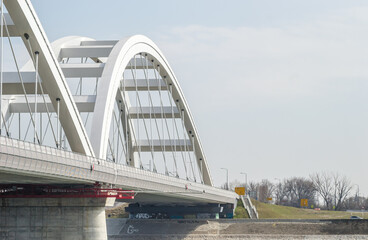 Obraz premium Novi Sad, Serbia - March 08. 2021: Zezelj bridge on river Danube in Novi Sad Serbia. The prospect of built New Zezelj Bridge viewed from the Petrovaradin side of the promenade.
