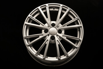 New modern alloy wheel close-up on a black background. Car beautiful