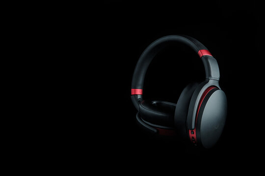 Black and red headphones on black.