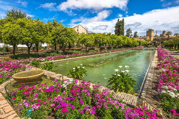 Fototapeta premium Cordoba, Andalusia, Spain - April 20, 2016: The colorful and blooming gardens in the spring of Alcazar de los Reyes Cristianos in Cordoba, Andalusia, Spain.