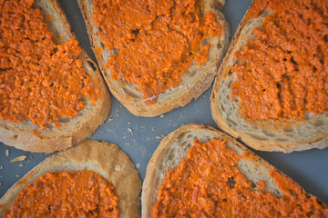 Directly above shot of slices of bread with vegan carrot spread.